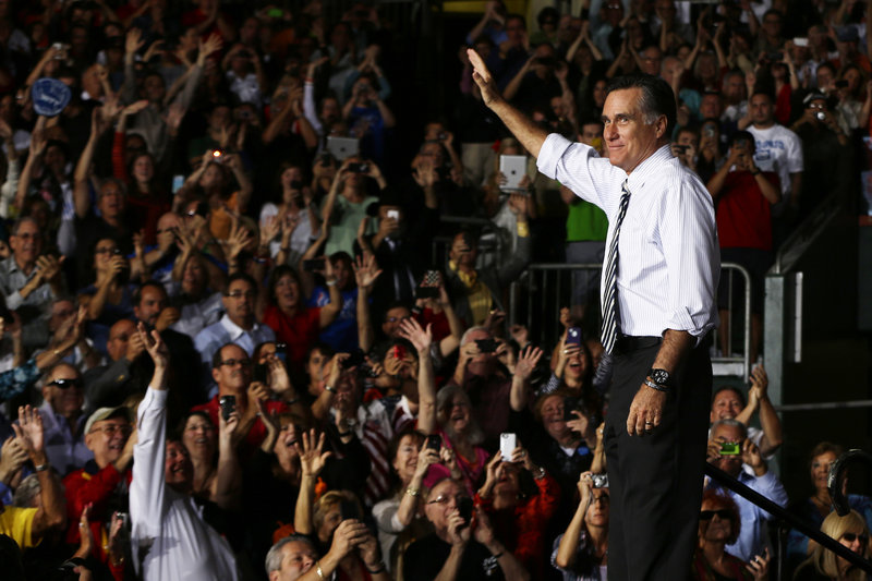 Mitt Romney waves during a campaign stop at the Bank United Center, at the University of Miami in Coral Gables, Fla., Wednesday.