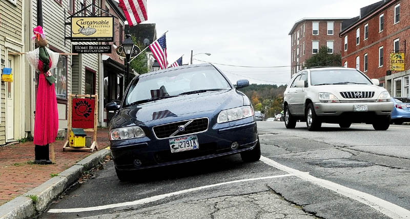Some of the parking spots on east side (the Kennebec River side) of Water Street in downtown Hallowell tilt down toward the sidewalk.