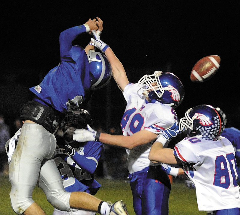BAT IT DOWN: If Lawrence’s Spencer Carey, left, played 20 years ago, he likely would have been a linebacker because of his size (6-2, 210 pounds). With more teams throwing the ball, his size is needed in the defensive secondary.