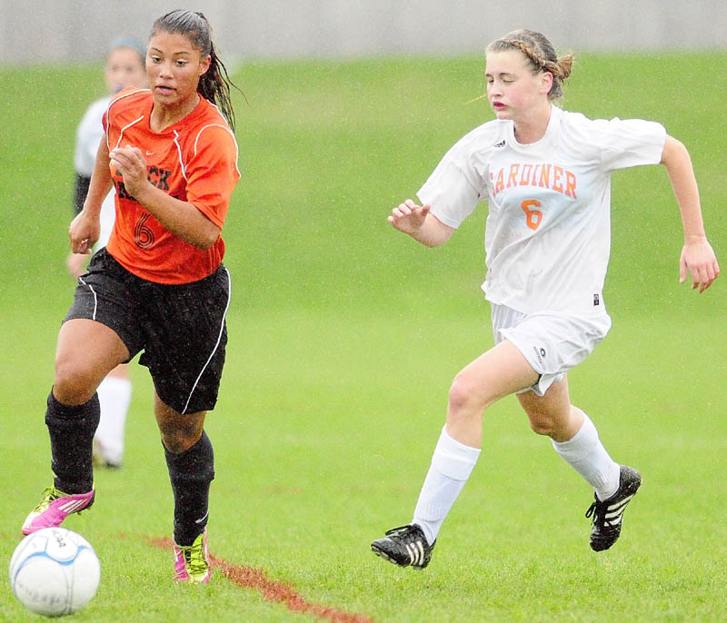 Staff photo by Joe Phelan Winslow's Alliyah Veilleux, left, and Gardiner's Maddy Noyes chase after a ball during a game on Wednesday afternoon in Augusta.