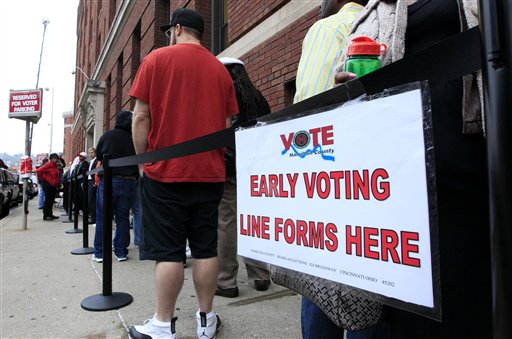 FILE - In this Oct. 2, 2012 file photo, voters stand in line outside the Hamilton County Board of Elections just before it opened for early voting, in Cincinnati. Stock up on munchies and make sure the batteries in your TV remote are fresh. With this year's presidential election razor-close to the finish, Tuesday could be a long night. Even if the presidency isn't decided until after midnight EST, there will be plenty of clues early in the evening on how things are going for President Barack Obama and Republican Mitt Romney. Obama has more options for piecing the 270 electoral votes needed for victory, so any early setbacks for Romney could be important portents of how the night will end. (AP Photo/Al Behrman, File)