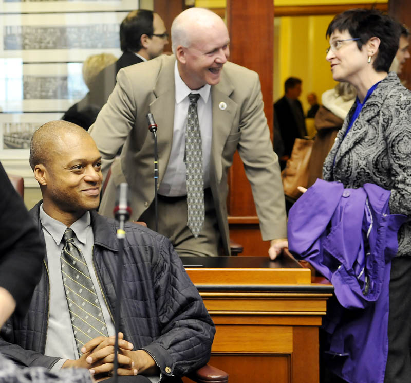 Kennebec County representatives-elect Craig Hickman, of Winthrop, left, Tim Marks, of Pittston, and Gay Grant, of Gardiner, wait to vote Tuesday on leadership of the House during a Democratic caucus.