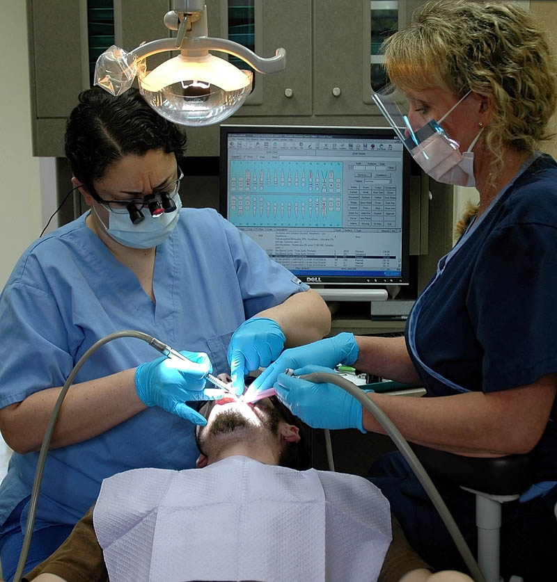 Dentist Tamara Diamond and hygienist Jackie Watson-Arsenault clean the teeth of patient Ronald Keith, 24, of Norridgewock, at the new dental facility at the Bingham Health Center on Wednesday