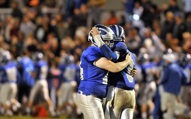 Lawrence High School quarterback Spencer Carey, right, celebrates a touchdown pass with Caleb Champagne during a game earlier this season. The Bulldogs face Cony in the Pine Tree Conference Class A title game today in Fairfield.