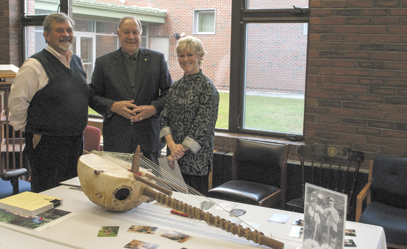 Dr. Tom Abbott, left, dean of the University of Maine at Augusta libraries, Dr. Hadley Smith, a former UMA professor of economics, and UMA President Allyson Handley, in UMA's Katz Library, where the Mandé kora was donated.