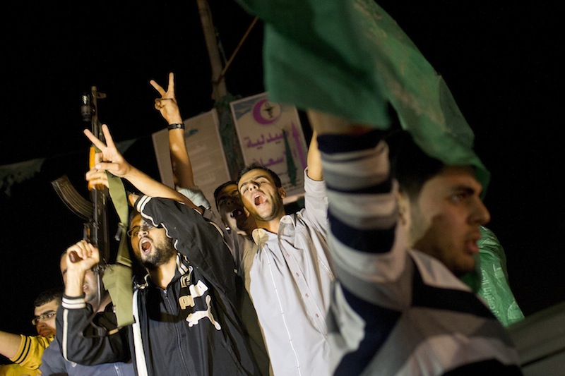 Palestinians celebrate the announcement of a cease-fire between Hamas and Israel in Gaza City, Wednesday, Nov. 21, 2012. Israel and the Hamas militant group agreed to a cease-fire Wednesday to end eight days of the fiercest fighting in nearly four years, promising to halt attacks on each other and ease an Israeli blockade constricting the Gaza Strip. (AP Photo/Bernat Armangue)