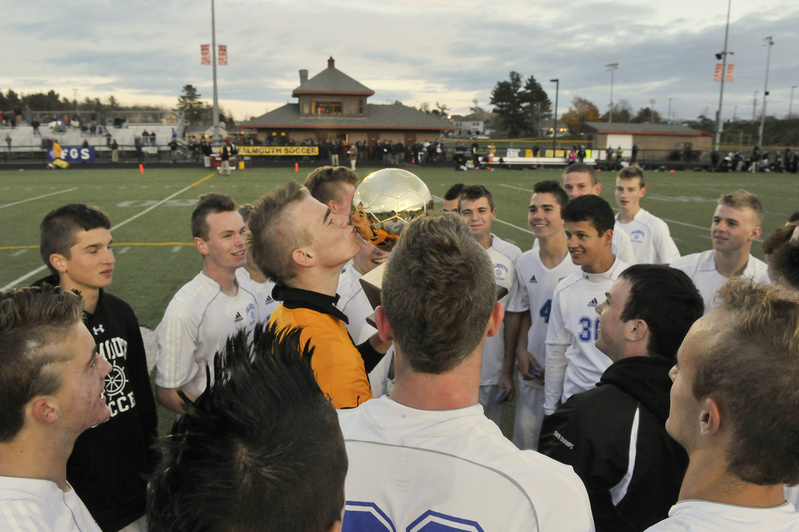 Falmouth goalie Will D’Agostino plants a kiss on the Gold Ball after the Yachtsmen knocked off Camden Hills, 2-1, to win the Class B state title.