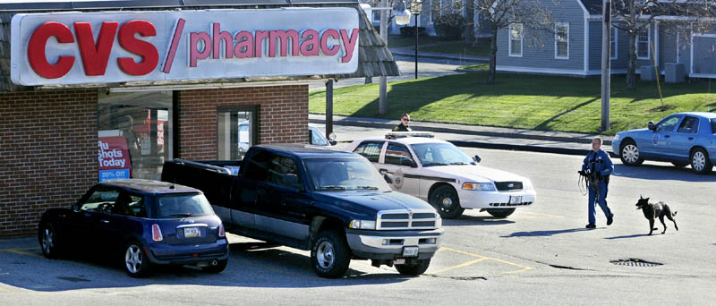 Augusta and State Police officers investigate a robbery reported about 11 a.m. today at the CVS Pharmacy on Capitol Street in Augusta.