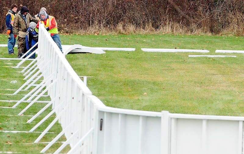 City workers set up the walls of an ice skating rink on Wednesday morning in the Calumet Playground in Augusta. The skating rink is located on Northern Avenue near the corner of Monroe Street.