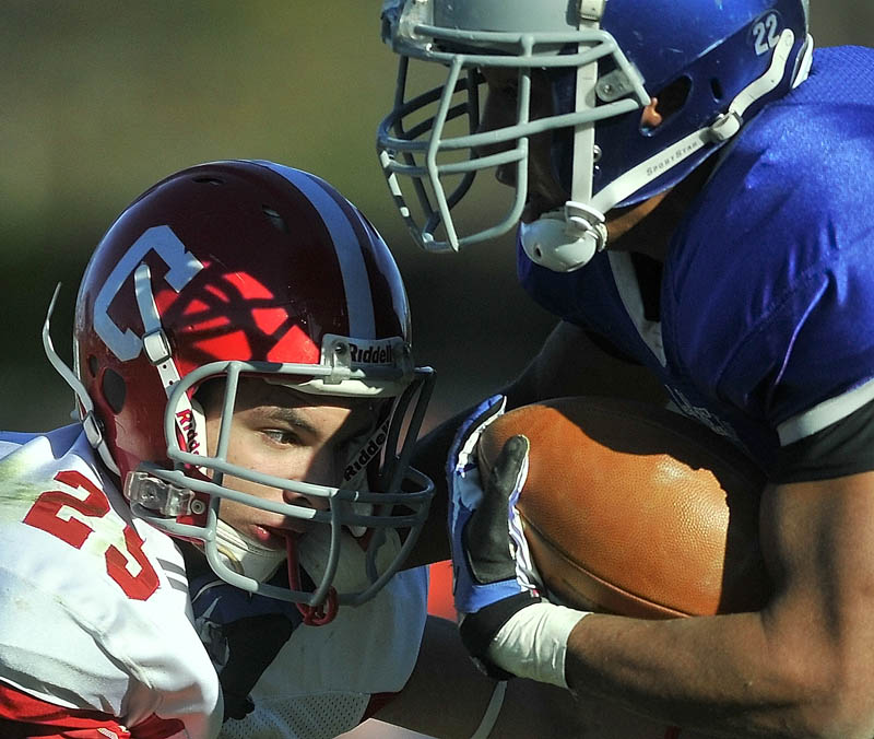 Staff photo by Jim Evans Cony High School's Tayler Carrier, left, gets an eyeful from Lawrence High School's Xavier Lewis Saturday.