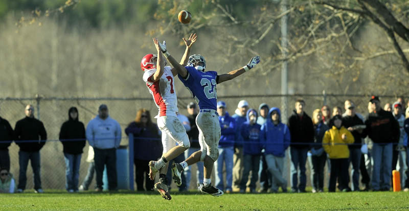 Cony High School's Chandler Shostack,left, and Lawrence High School's Xavier Lewis both make a play on a long Cony pass, but the fall fell incomplete Saturday.