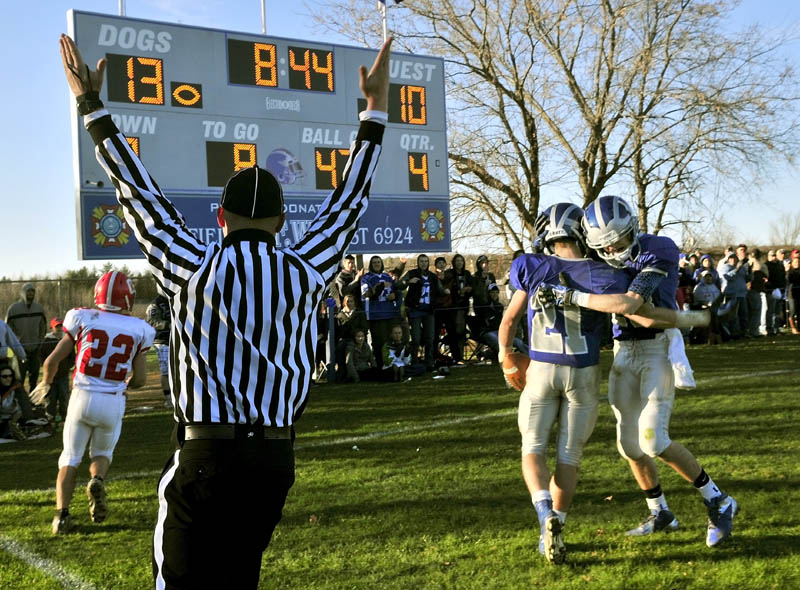 Lawrence High School's Josh Doolan (21) is congratulated by his teammate Aaron LaFrance after putting another six points on their homefield scoreboard Saturday. Lawrence won 20-10. Cony High School's John Bennett wasn't able to stop Doolan on the 47-yard touchdown run.