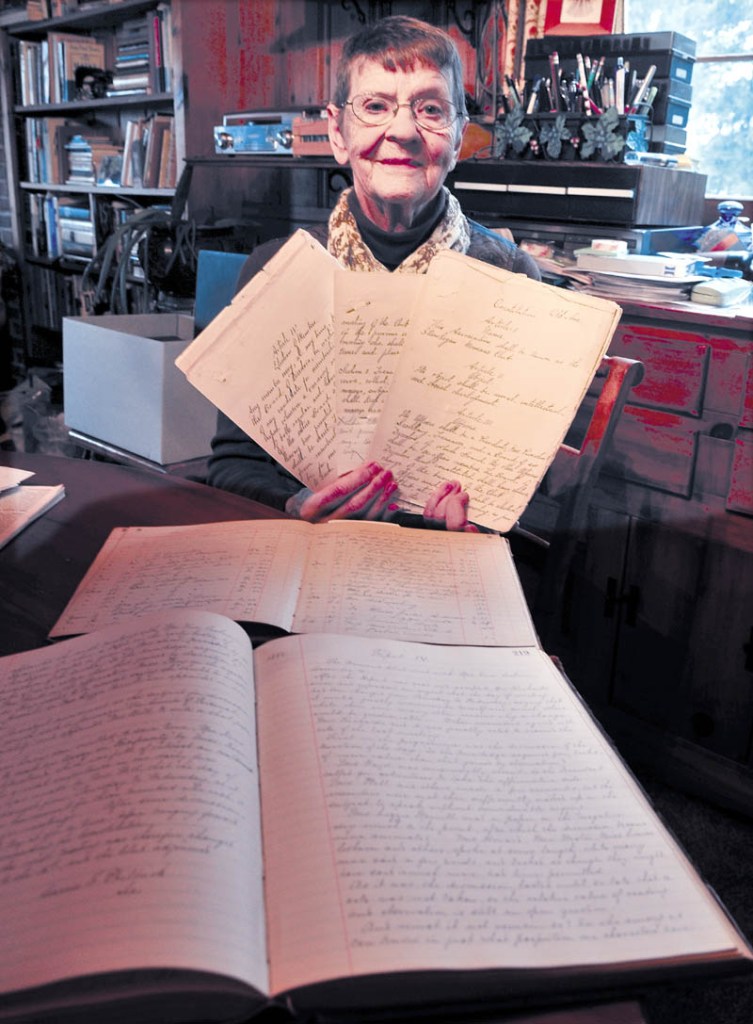 Maxine Russakoff holds some documents, including the 1882 constitution of the Skowhegan Women's Club. The organization is celebrating its 130th anniversary.