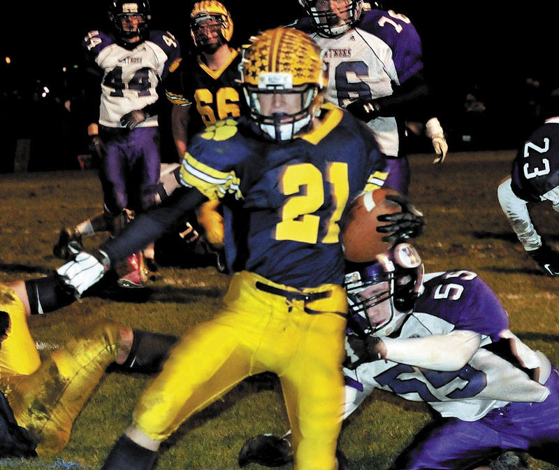 OFF AND RUNNING: Mt. Blue’s Nate Backus gets past Waterville’s Duncan Works during the Eastern B final Friday in Farmington. Mt. Blue won 42-14.