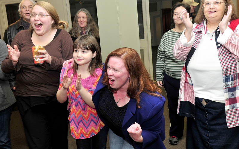 Colleen Lachowicz, Democratic candidate for Senate District 25, center, reacts after her husband Ed announced that she beat opponent Tom Martin in Waterville on Tuesday. At left are Rebecca Parker and Courtney Cote.