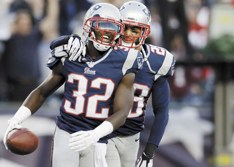IT’S OVER: New England Patriots cornerback Devin McCourty, left, celebrates with safety Steve Gregory after McCourty intercepted a pass in the end zone against the Buffalo Bills in the last minutes of the Patriots’ 37-31 win Sunday at Gillette Stadium in Foxborough, Mass. NFLACTION12; Gillette Stadium