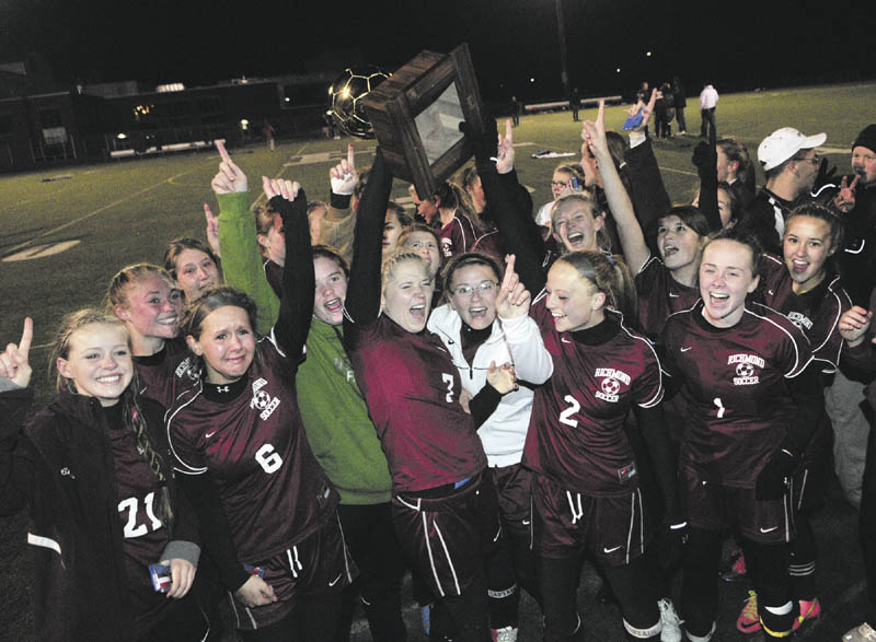 WE DID IT: Richmond players hold up the gold ball after beating Washburn 2-1 on penalty kicks to win the Class D state championship Saturday night in Hampden.