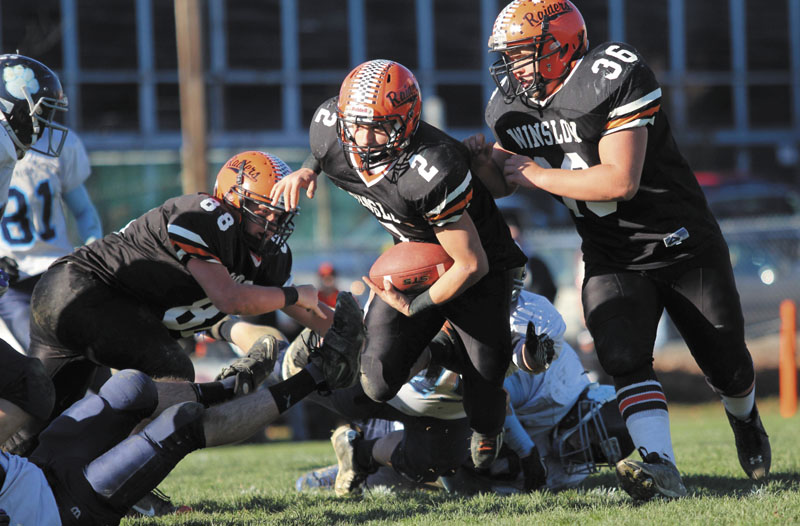 LOOKING FOR RUNNING ROOM: Winslow High School's Joseph Hopkins looks upfield for extra yardage after eluding several Dirigo High School defenders during the first half of the Black Raiders' 17-6 victory over the Cougars in the Western Maine Class C final on Saturday.