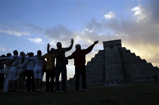 People gesture toward the the Kukulkan temple in Chichen Itza, Mexico on Friday.