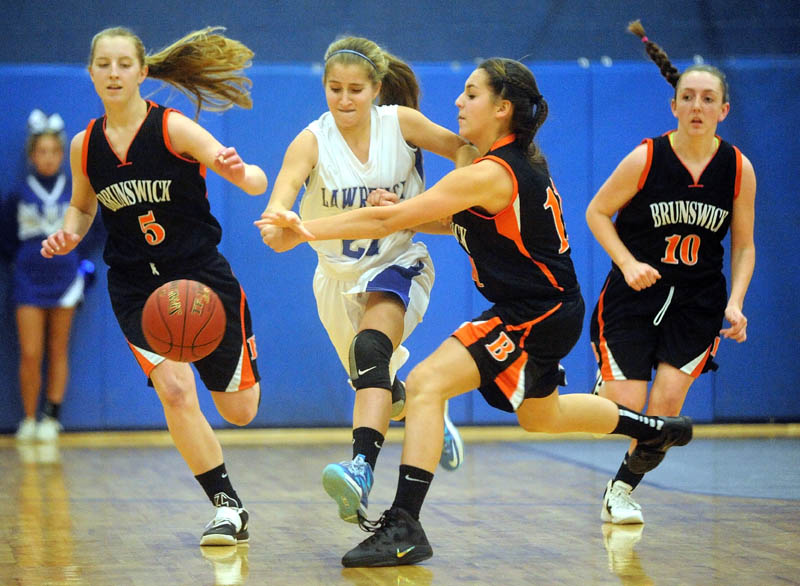 Lawrence High School's Dominique Lewis, left, battles for the loose ball with Brunswick High School's Julia Champagne, right, in the first quarter Tuesday at Lawrence High School in Fairfield.