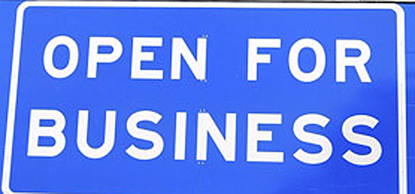 In this Friday 2011 file photo, an "Open for Business" sign beneath the "Welcome to Maine" sign along Interstate 95 near the New Hampshire border in Kittery. For the third consecutive year, Maine ranked No. 50 in Forbes' seventh annual “Best States for Business.”