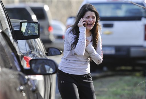 A woman waits to hear about her sister, a teacher, following a shooting at the Sandy Hook Elementary School in Newtown, Conn., on Friday.