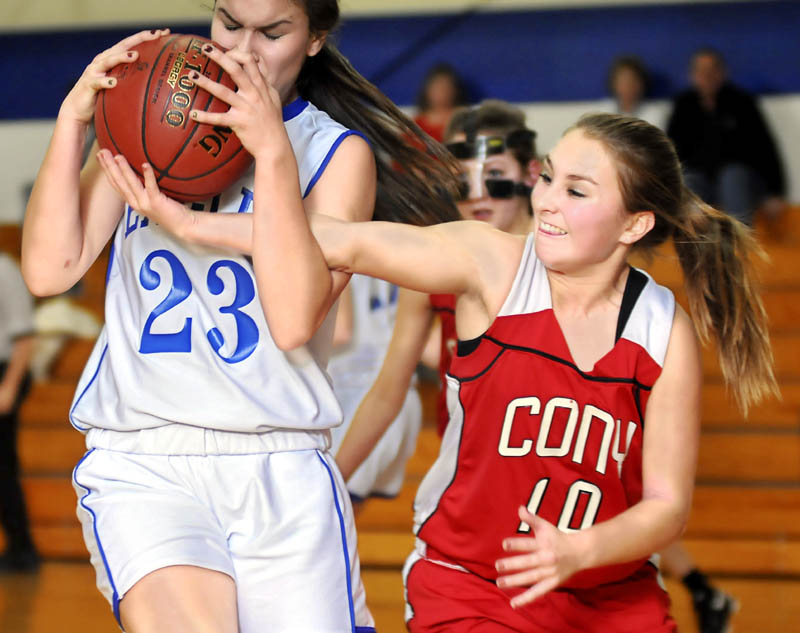 HANG ON: Erskine Academy’s Bridget Humphrey, left, holds a rebound under pressure from Cony High School’s Olivia Deeves during the Rams’ 60-40 win Thursday in South China.