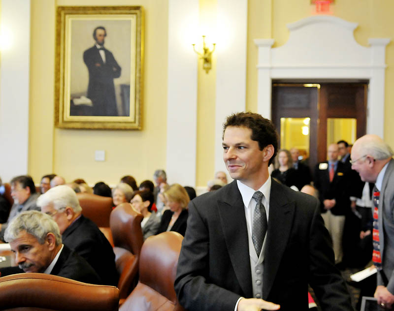 Sen. Justin Alfond, D-Portland, walks to the Senate president's podium on Wednesday after being confirmed by his colleagues in the Senate. All Senate and House members were sworn in for the 126th Legislature by Gov. Paul LePage.