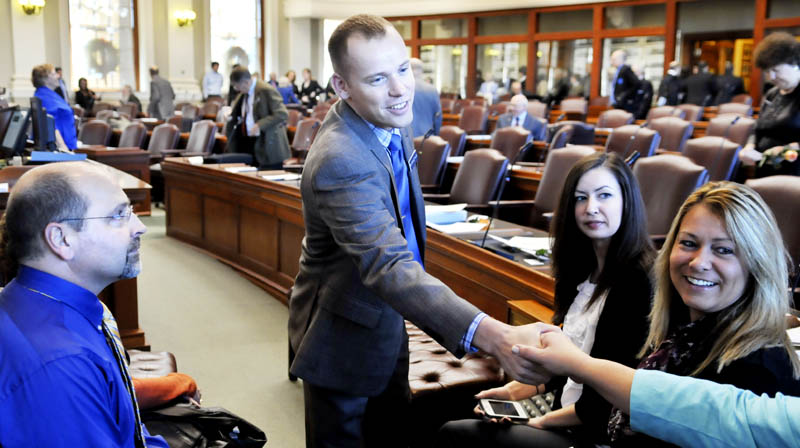 Corey Wilson, R-Augusta, greets well wishers Wednesday before taking the oath of office in the House of Representatives in Augusta.