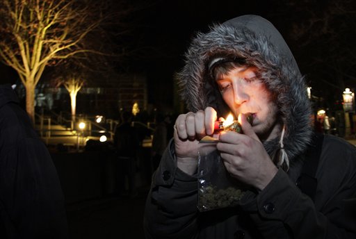 C. Nash smokes marijuana just after midnight at the Space Needle in Seattle. Possession of marijuana became legal in Washington state at midnight, and several hundred people gathered at the Space Needle to smoke and celebrate the occasion, even though the new law does prohibit public use of marijuana.