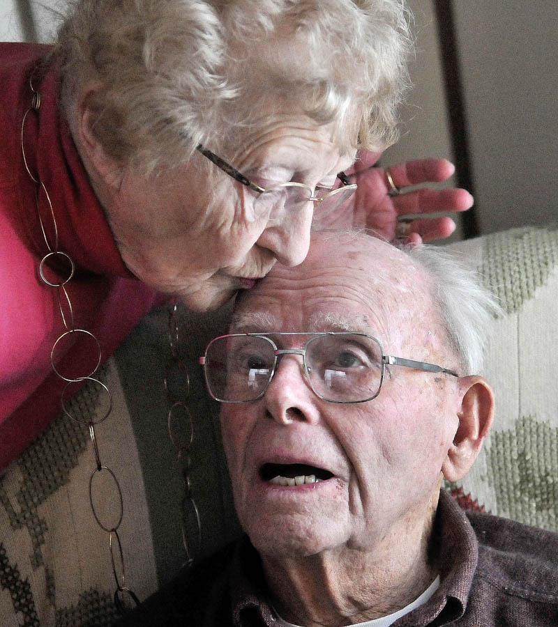 Charlotte Lovejoy kisses her husband, Del, while at home on Summer Street in Oakland on Thursday.