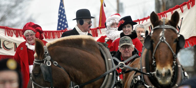 Mr. and Mrs. Claus lead the Chester Greenwood Day parade down Main Street in downtown Farmington Saturday.