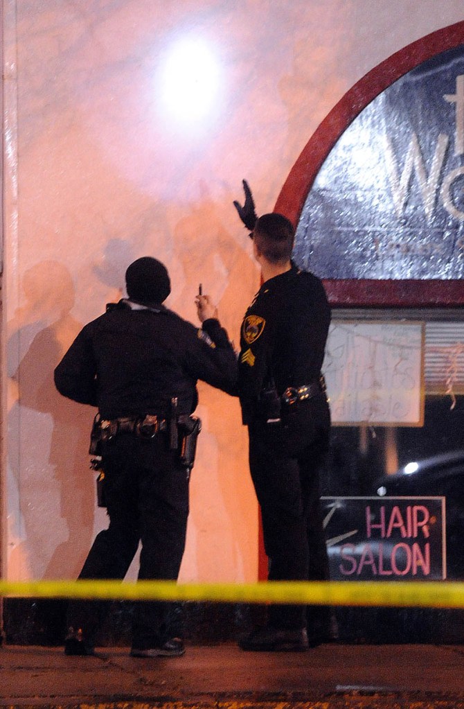 Staff photo by Michael G. Seamans Police investigate the scene where a man was shot on The Concourse late Tuesday night in Waterville.