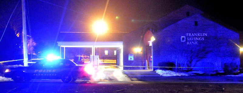 A Skowhegan police cruiser sits parked next to Franklin Savings Bank on Madison Avenue after a robbery on Dec. 13.