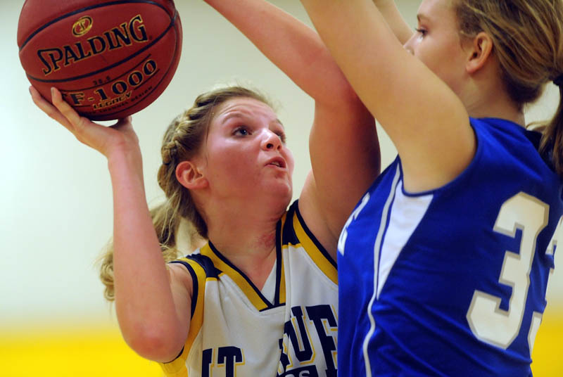 Staff photo by Michael G. Seamans Mt. Blue High School's Jaycee Jenckes, left, tries to get a shoot over Lawrence High School defender Nia Irving in the first quarter Friday at Mt. Blue High School in Farmington.