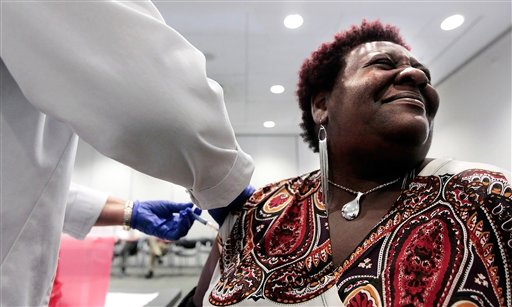 Elizabeth Saint Victor winces as she gets a free flu shot from LPN Jean Buck courtesy of Baptist Healthcare in Memphis, Tenn., recently.