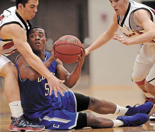 HELP ME: Colby College’s Shane Rogers, center, tries to pass the ball as Thomas College defenders Adam Carlsen, left,, and Ray Bernier try to make a steal Tuesday at Thomas College in Waterville Tuesday. Thomas defeated Colby 88-83.
