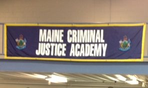 Members of the Maine Criminal Justice Academy's latest graduating class with the gifts they gathered to donate to charity.