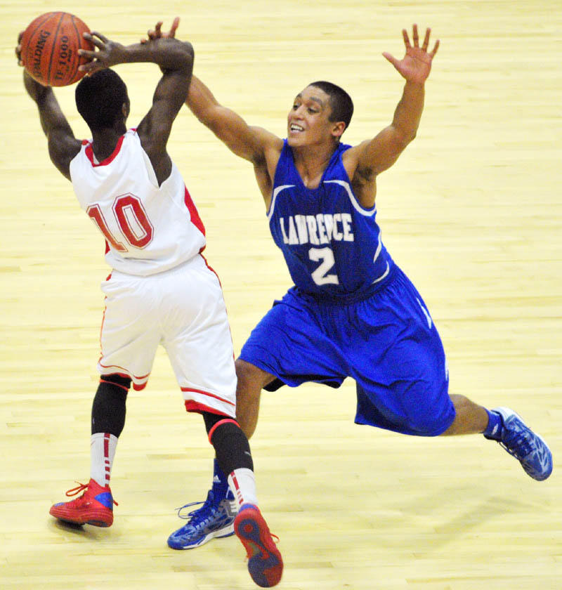 MAKE A PASS: Cony’s Dayshawn Roberts, left, looks for a teammate to pass to as Lawrence’s Xavier Lewis plays tight defense during the Bulldogs’ 53-39 win Friday at the Capital City Hoop Classic at the Augusta Civic Center.