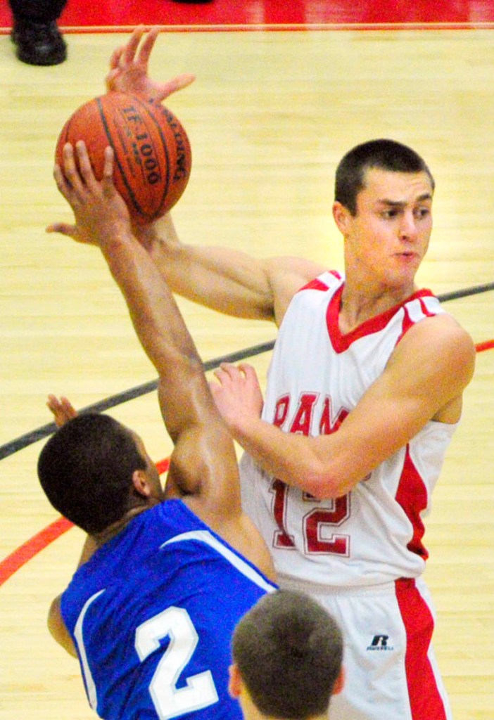 TOUGH D: Lawrence’s Xavier Lewis knocks the ball away from Cony’s Chandler Shostak during the Bulldogs’ 53-39 win Friday at Capital City Hoop Classic at the Augusta Civic Center.