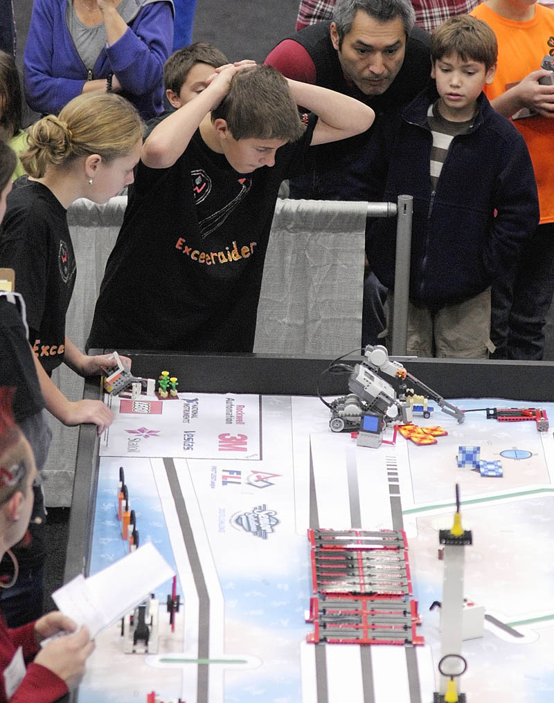 Adrienne Lakey, left, and Noah Michaud, of Winslow Junior High School, watch their team's robot to compete at the 13th annual Maine First LEGO League Championship on Saturday, at the Augusta Civic Center. Only two members at a time can stand beside the table and run the robot.