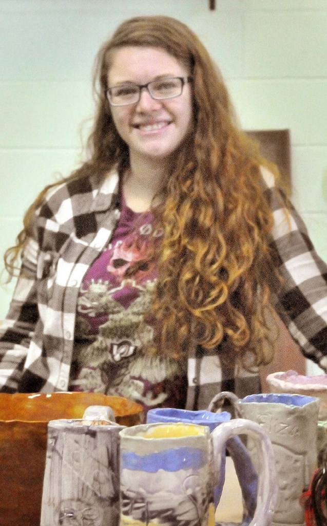 Yvonne Bollenbacher, 24, stands in the studio of Skowhegan Pottery, surrounded by brushes, pottery and clay to be packed. The studio is closing this month.