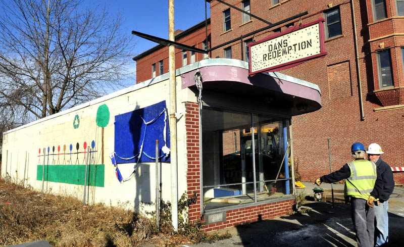 Homer Salisbury, right, superintendent for the Sheridan Corp., speaks with a Kennebec Water District employee outside Dan's Redemption, next to the former Gerald Hotel, in Fairfield on Thursday. The business will be torn down to make room from a driveway to the entrance of the hotel building, which will be turned into senior housing.