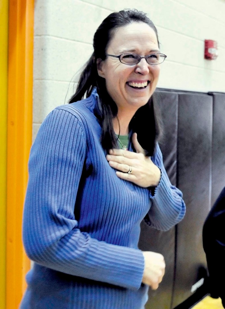 Staff photo by David Leaming REACT: Skowhegan Area Middle School teacher Margaret Pietrak reacts with surprise and joy after it was announced that her science class was awarded a $1,000 check from S.W. Cole Engineering Inc. as winners in the company’s annual “Dig Into Science” contest on Thursday, Dec. 13, 2012.