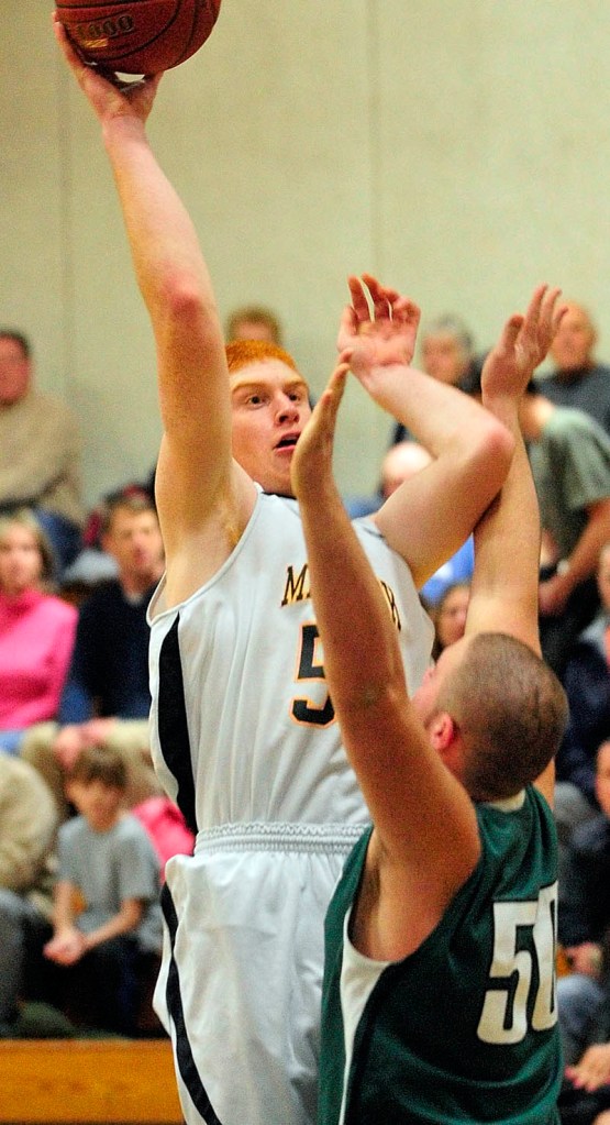 UP AND OVER: Maranacook’s Kyle Boucher, left, takes a shot over Leavitt’s Matt Powell during a game Tuesday in the Mr. Burbank Memorial Gym in Readfield.