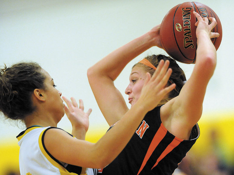 Mt. Blue High School's Kayla Newbill, 31, pressures Skowhegan High School's Adriana Martineau, 23, right, in the first quarter at Mt. Blue High School in Farmington.