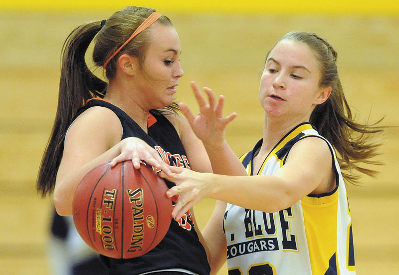 TOUGH D: Mt. Blue High School’s Mackenzie Conlogue, right, pressures Skowhegan High School’s Desiree Brochu, left, in the second quarter Friday in Farmington.