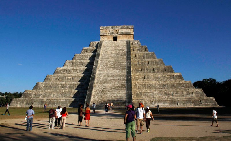 The Mayan ruins at Chichen Itza, Mexico, attract visitors Thursday. Meanwhile, hundreds of spiritualists gathered at a convention center in the Yucatan city of Merida, an hour and a half away. “It is a cosmic dawn,” one declared.