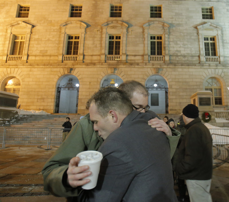 Coming to Portland from Augusta to support same-sex couples, Matthew Martin, left, and Russell Vonaa embrace outside City Hall on Saturday.