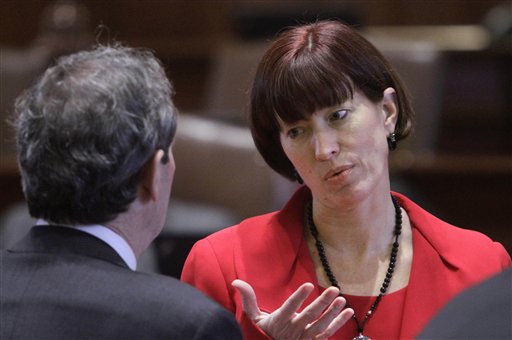 FILE - In this Feb. 8, 2012 file photo, Illinois Sen. Heather Steans, D-Chicago, right, confers with Illinois Senate President John Cullerton, D-Chicago, on the Senate floor during session at the Illinois State Capitol in Springfield, Ill. Advocates of legalized gay marriage in Illinois are pleased that Steans and state Rep. Greg Harris are planning to push for approval in January. Steans and Harris say they believe they have the votes necessary to fulfill Gov. Pat Quinn's hope of signing same-sex marriage into law in January. (AP Photo/Seth Perlman, File)